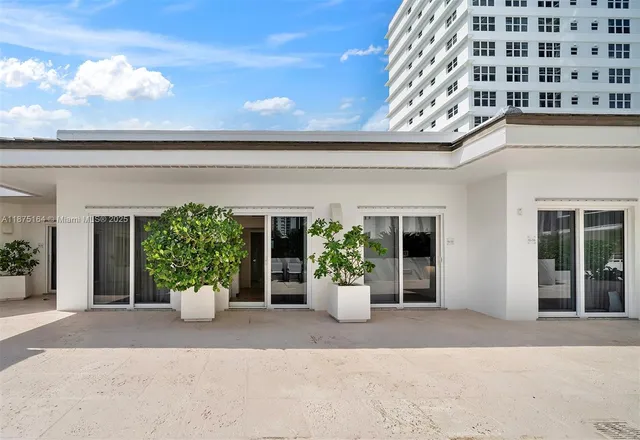 front view of a house with potted plants