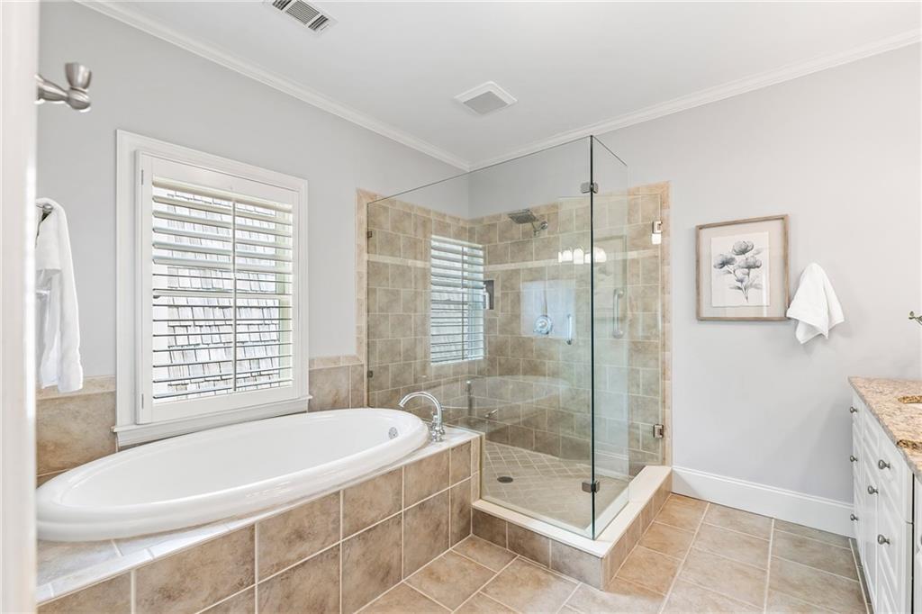 6645 Will Allen Road Cumming, GA 30040 - Photo 34 of 62 a bathroom with a large tub a shower and checkered floor