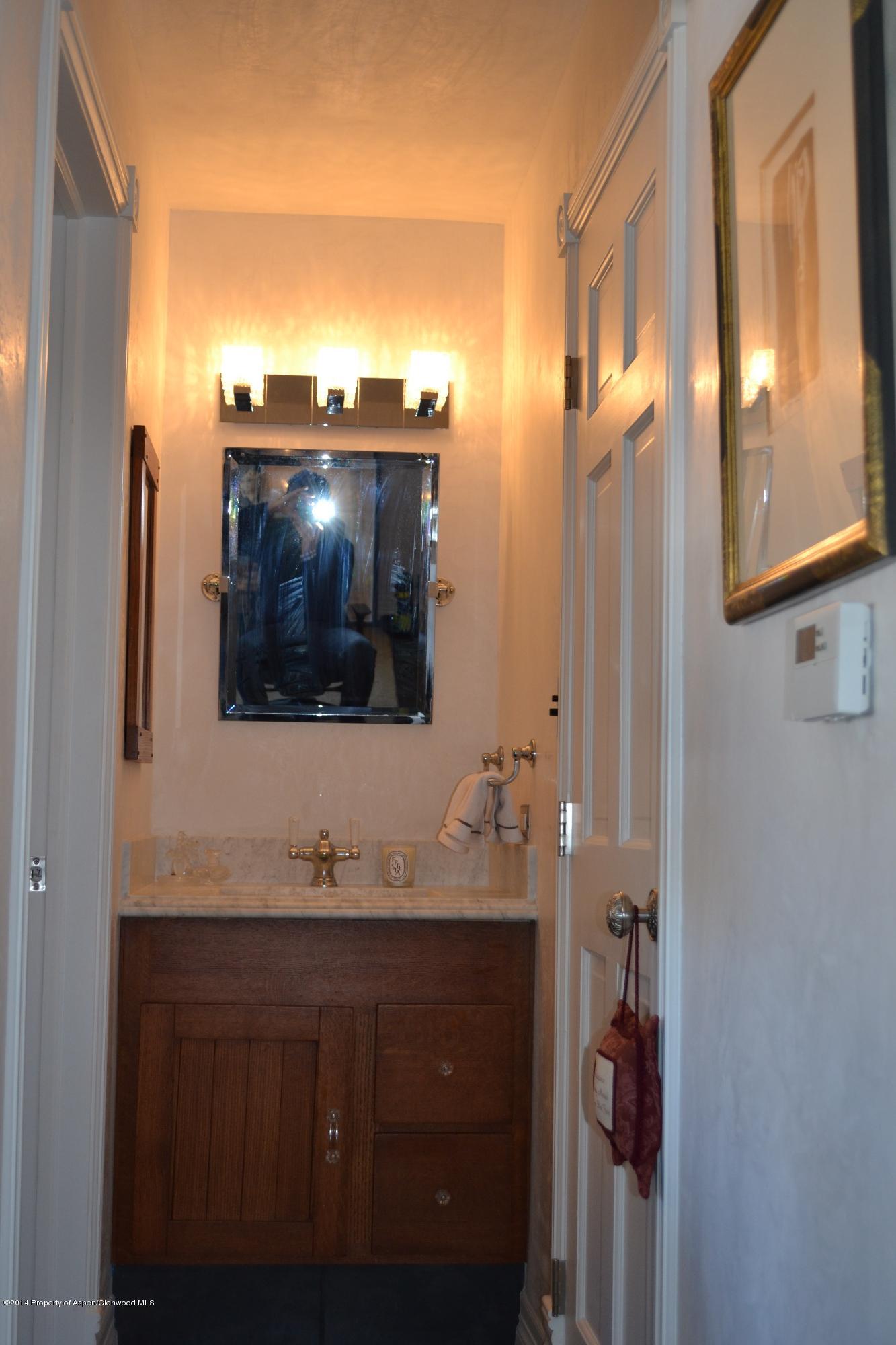 1041 Vine Street Aspen, CO 81611 - Photo 12 of 16 a bathroom with a sink and a mirror