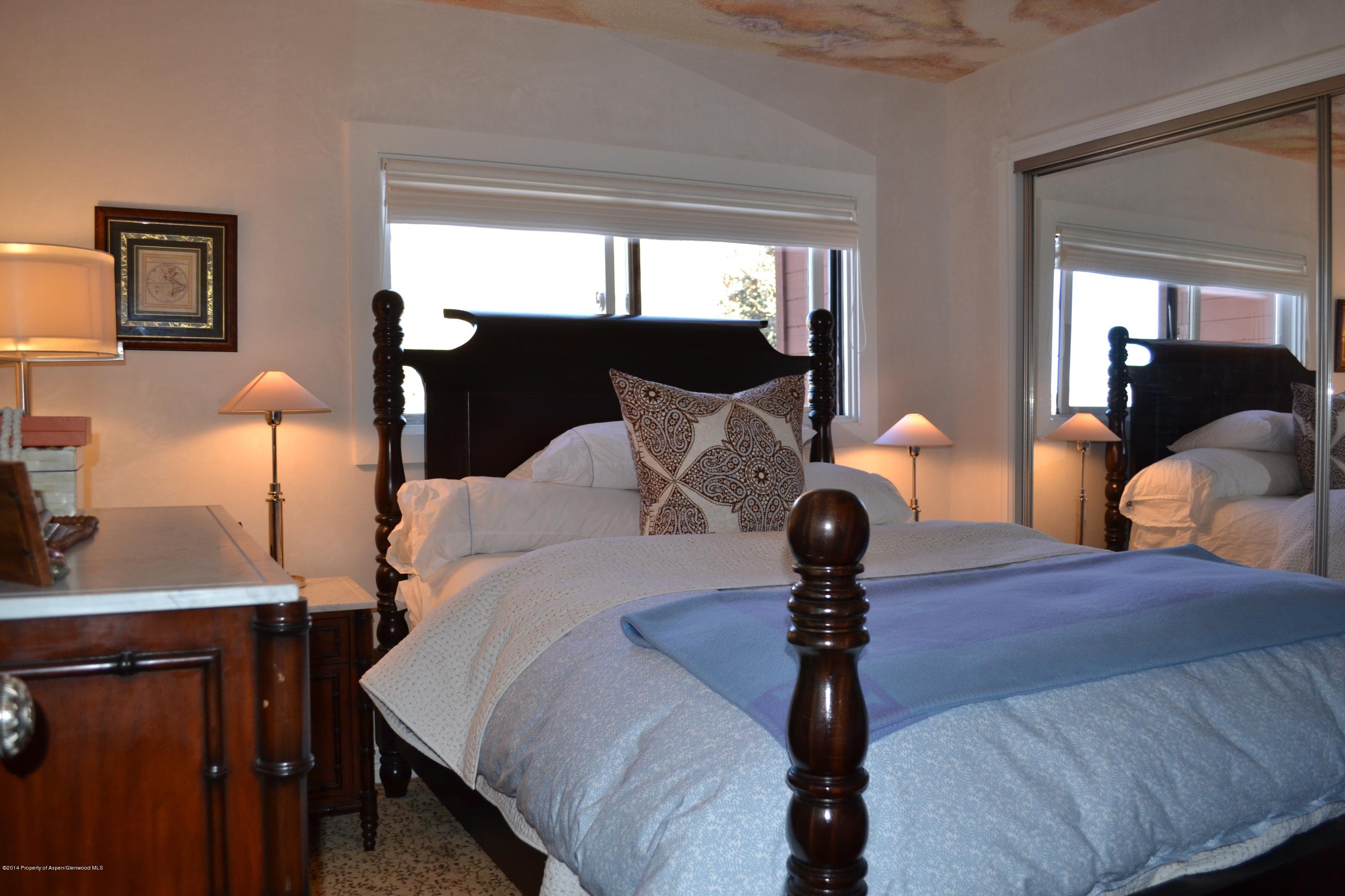 1041 Vine Street Aspen, CO 81611 - Photo 10 of 16 a bed room with a bed and a lamp