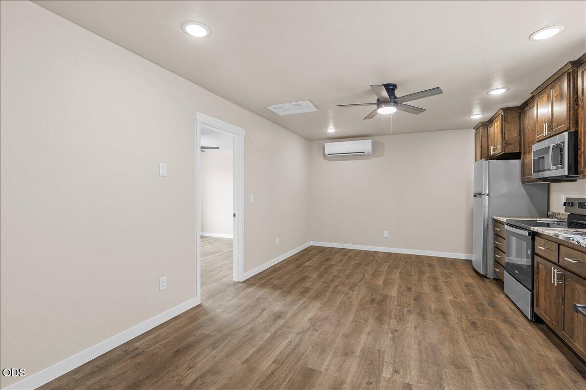 7869 Houston Loop White City, OR 97503 - Photo 9 of 15 wooden floor in an empty room with a window