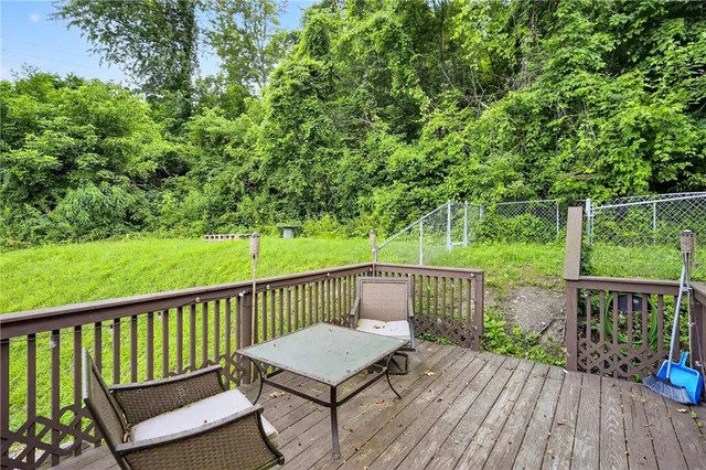 a view of a wooden deck with a yard