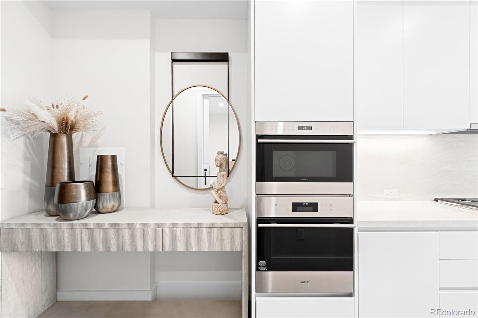 1901 Wazee Street, Unit 304 Denver, CO 80202 - Photo 11 of 38 a kitchen with stainless steel appliances a stove and a microwave