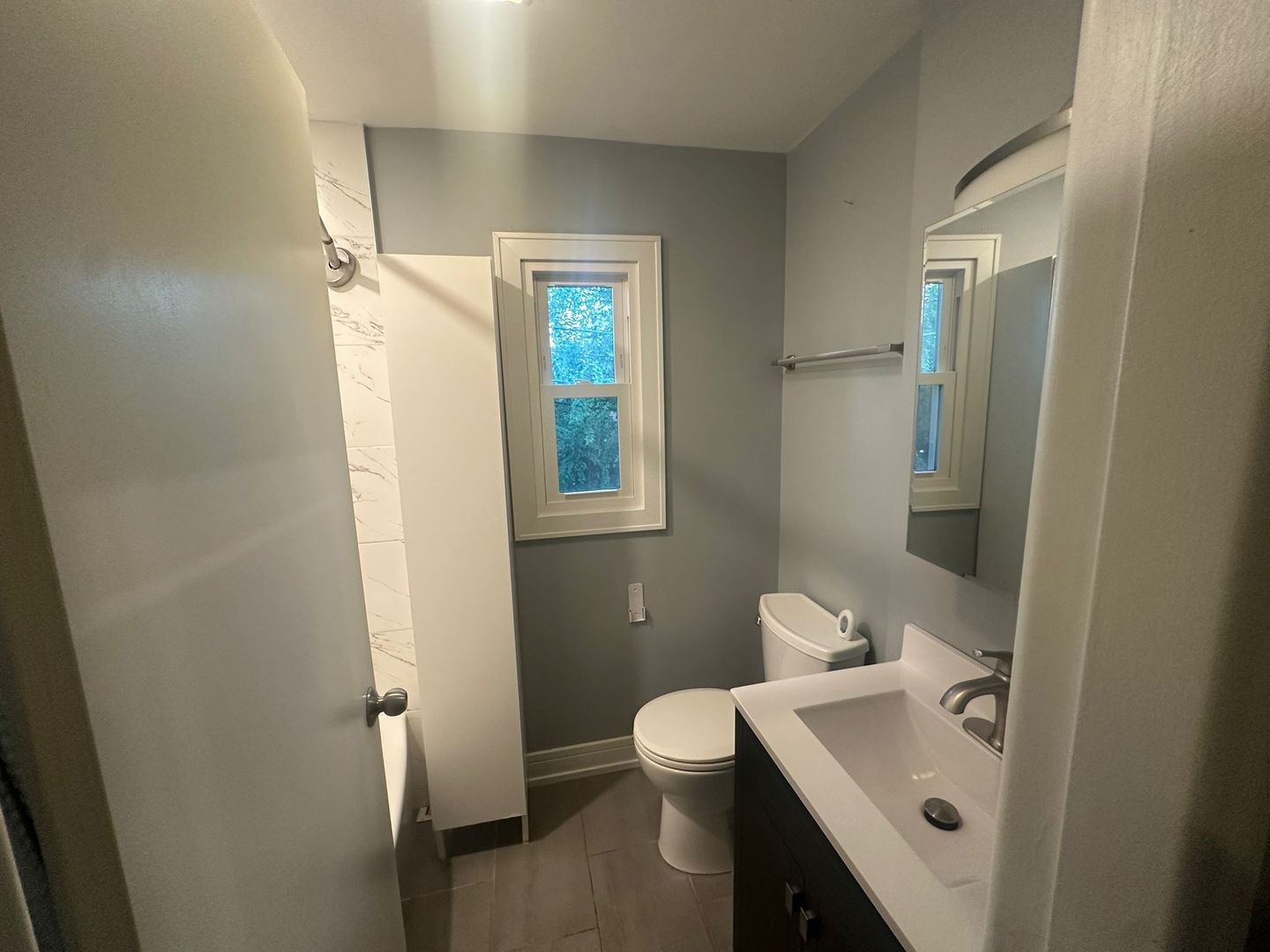 2543 Crawford Avenue, Unit 2543 Evanston, IL 60201 - Photo 12 of 17 a bathroom with a sink mirror and toilet
