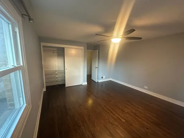 a view of a livingroom with wooden floor and a window