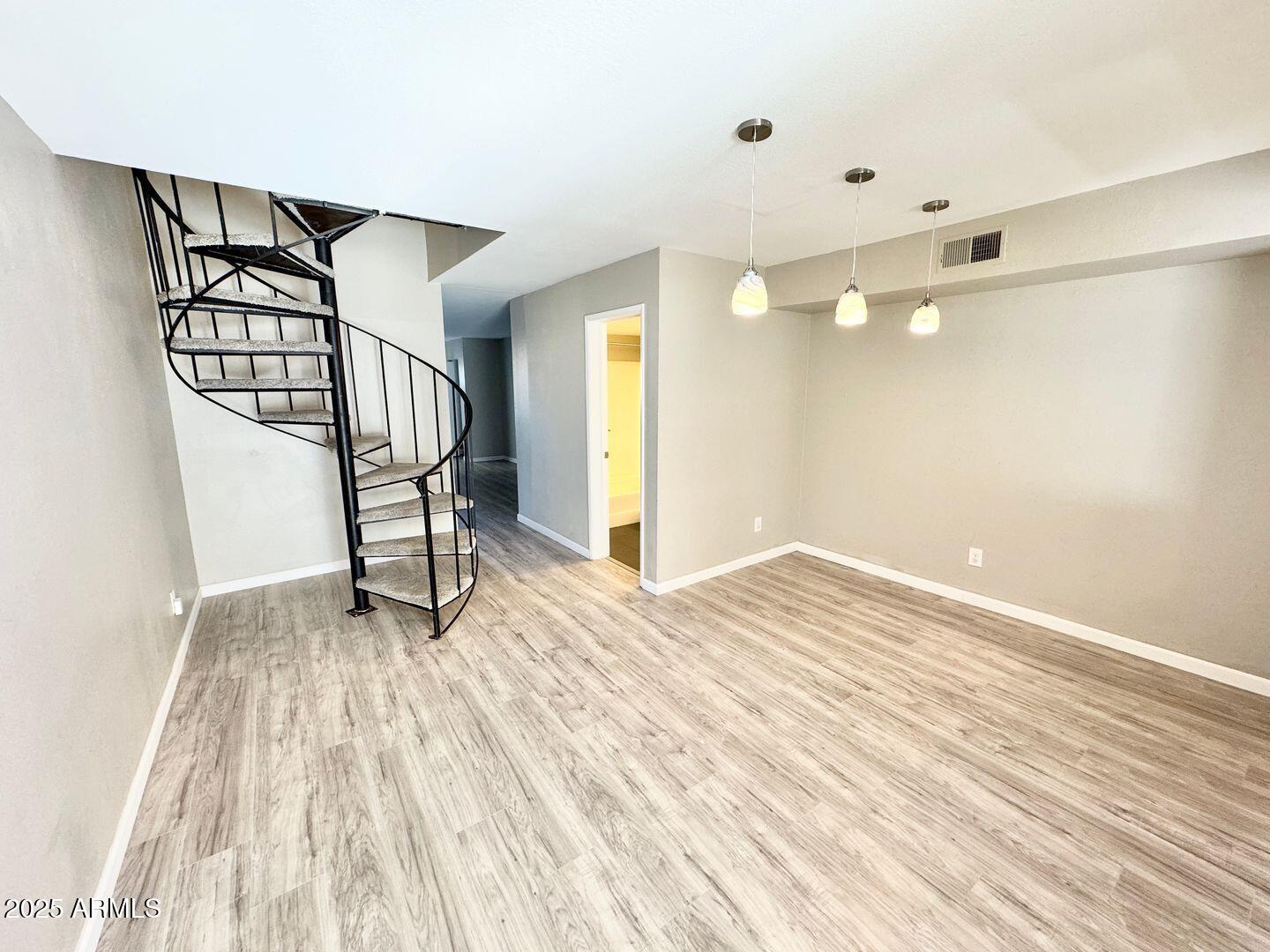 1425 East Desert Cove Avenue, Unit 2 Phoenix, AZ 85020 - Photo 13 of 42 a view of an empty room with wooden floor