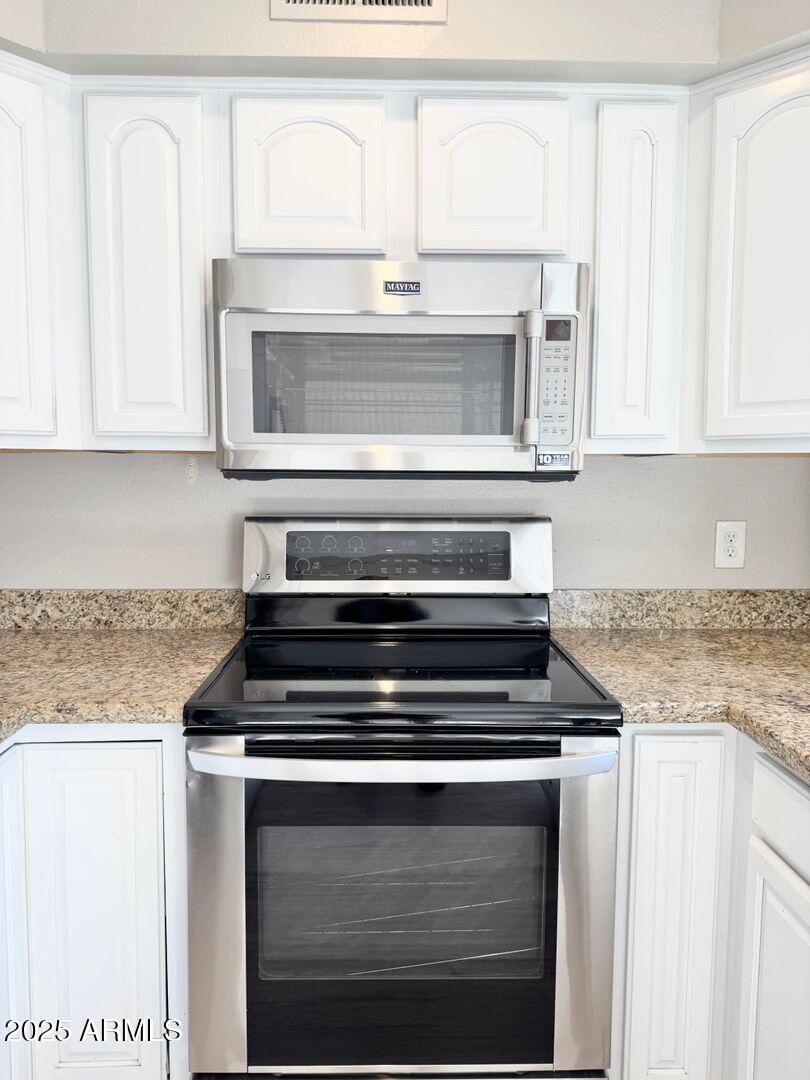 1425 East Desert Cove Avenue, Unit 2 Phoenix, AZ 85020 - Photo 19 of 42 a stove top oven sitting inside of a kitchen