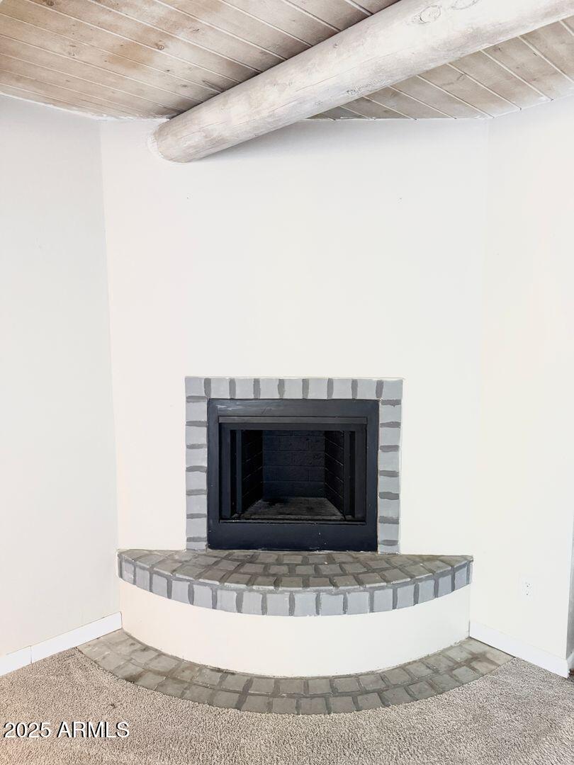 1425 East Desert Cove Avenue, Unit 2 Phoenix, AZ 85020 - Photo 26 of 42 a living room with a fireplace and a rug