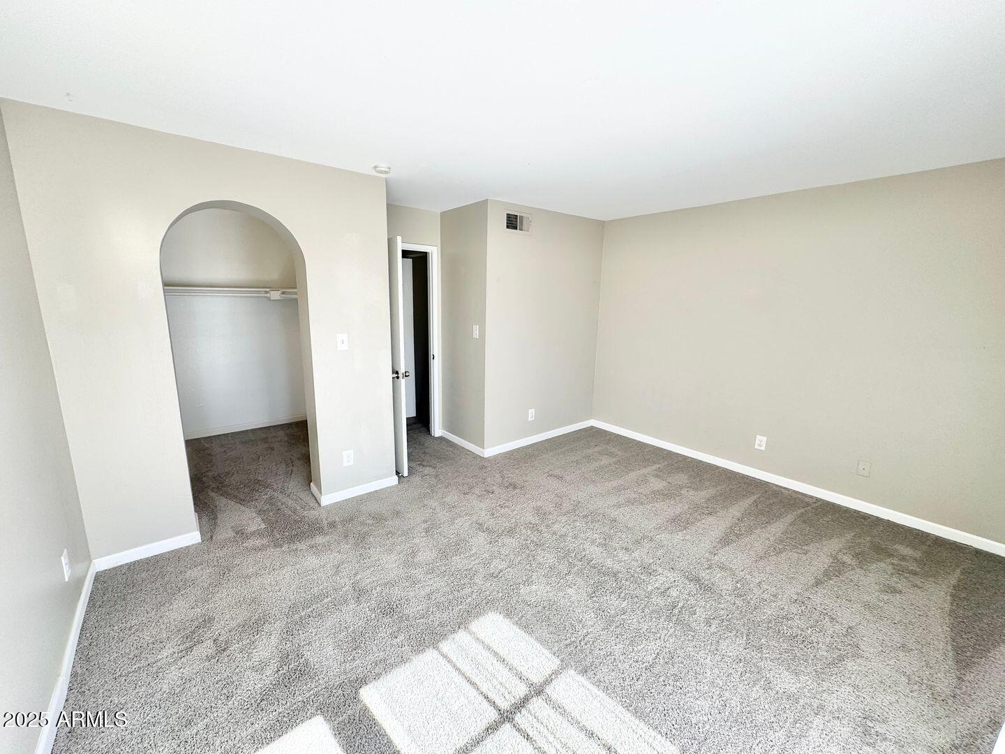 1425 East Desert Cove Avenue, Unit 2 Phoenix, AZ 85020 - Photo 31 of 42 an empty room with a fireplace and wooden floor