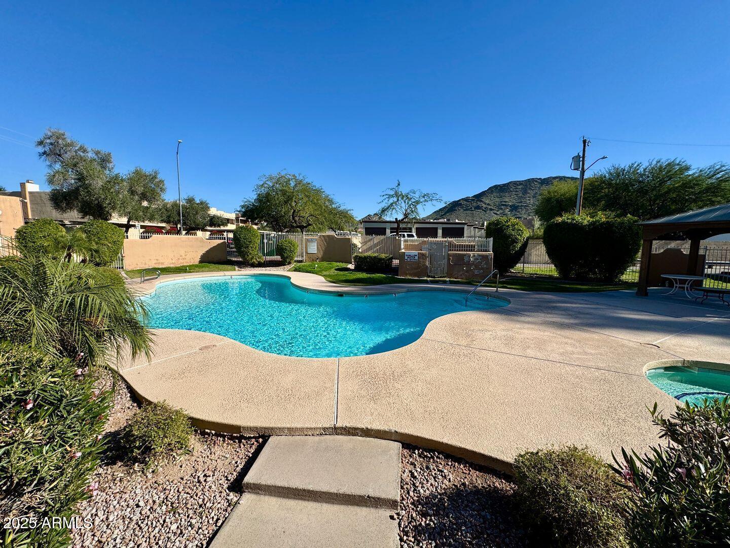 1425 East Desert Cove Avenue, Unit 2 Phoenix, AZ 85020 - Photo 40 of 42 a view of a swimming pool with a yard