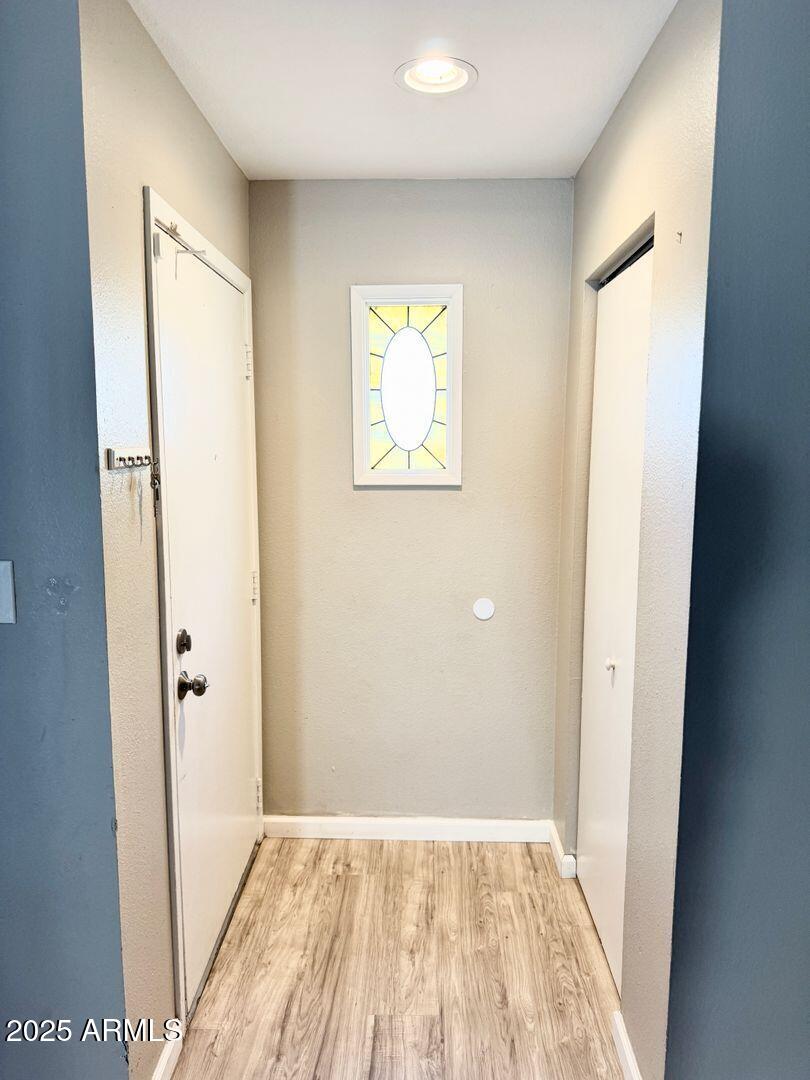 1425 East Desert Cove Avenue, Unit 2 Phoenix, AZ 85020 - Photo 4 of 42 wooden floor in a empty room with a window
