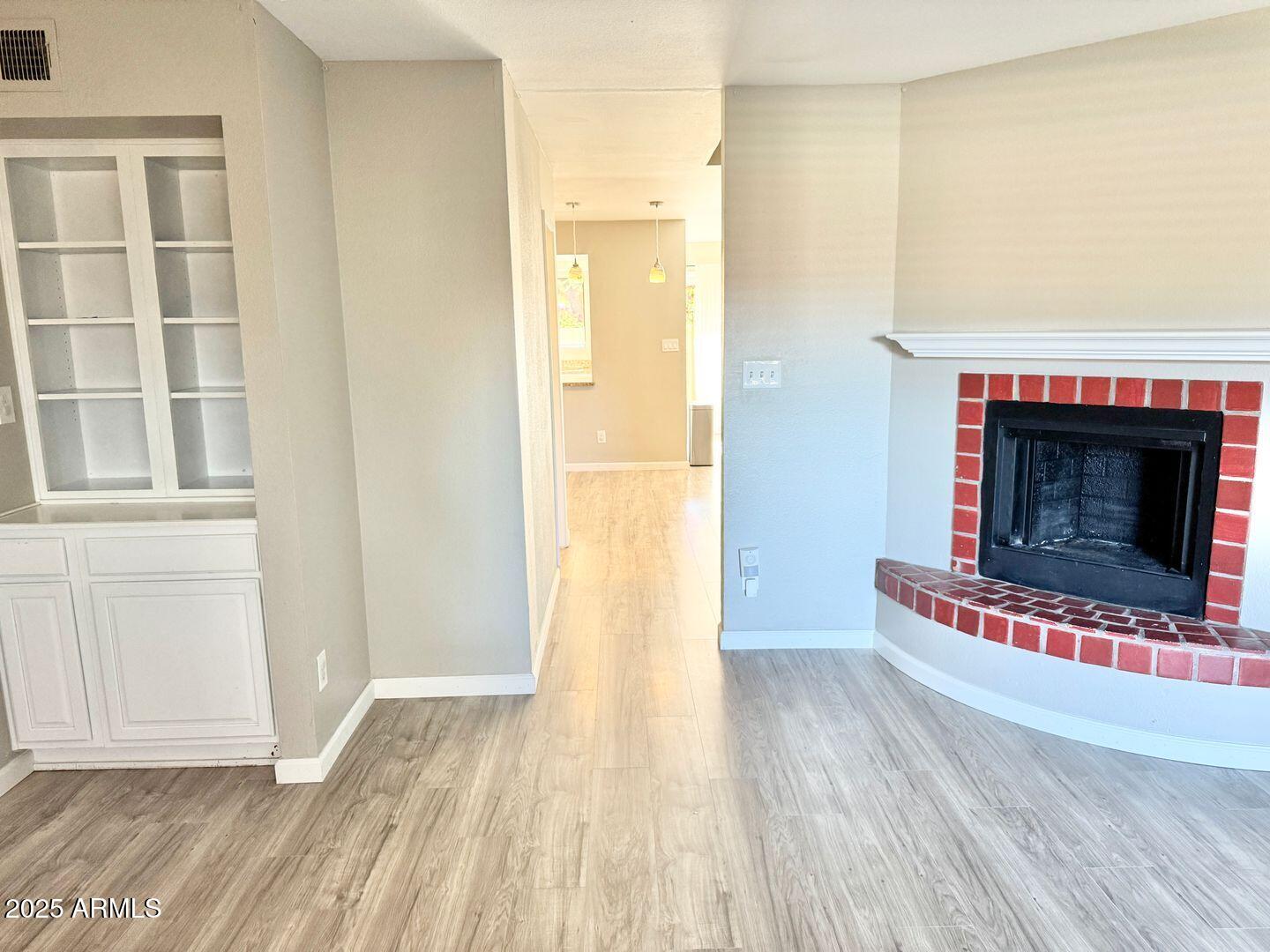 1425 East Desert Cove Avenue, Unit 2 Phoenix, AZ 85020 - Photo 9 of 42 a view of a livingroom with wooden floor and a fireplace
