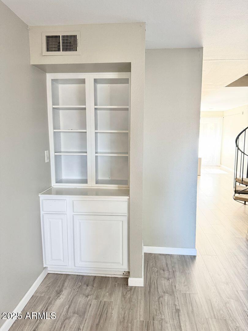 1425 East Desert Cove Avenue, Unit 2 Phoenix, AZ 85020 - Photo 10 of 42 a view of a room with wooden floor and cabinet