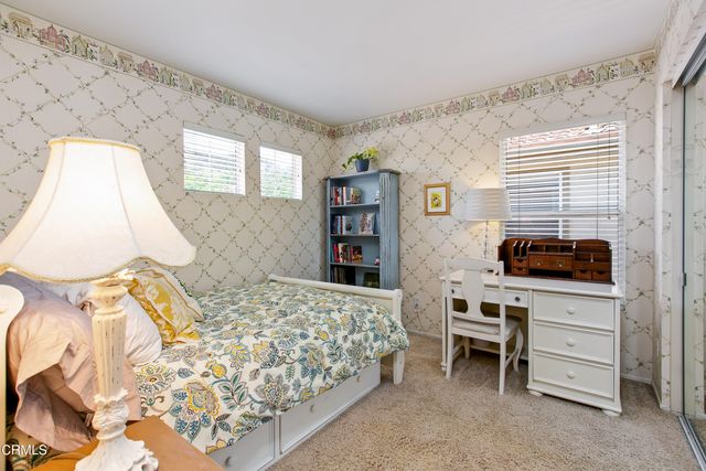 a bedroom with a bed and a desk