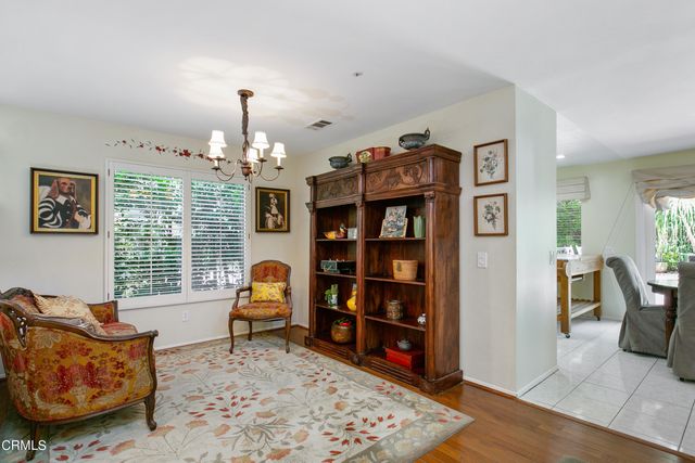 a living room with furniture a rug and a chandelier