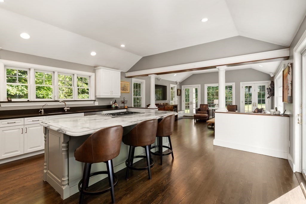 88 Pine Street Dover, MA 02030 - Photo 13 of 40 a living room with stainless steel appliances granite countertop a couch a table and chairs in it