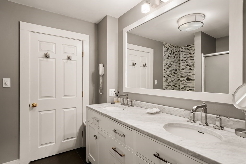 88 Pine Street Dover, MA 02030 - Photo 28 of 40 a bathroom with a double vanity sink a mirror and shower