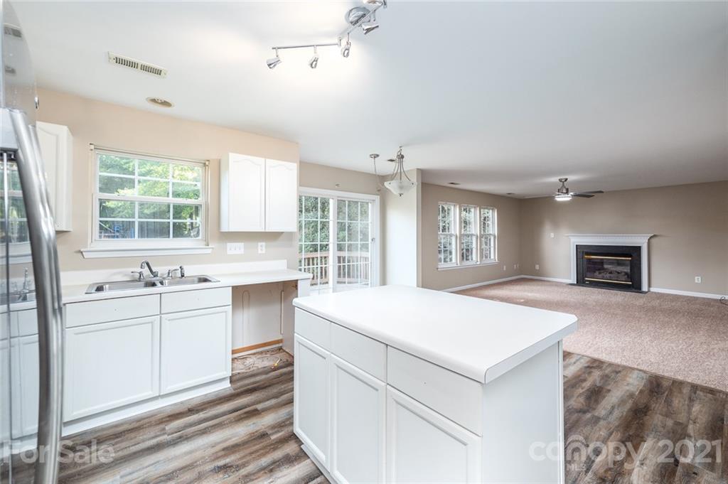840 Knightsbridge Road Fort Mill, SC 29708 - Photo 12 of 32 a large white kitchen with cabinets and wooden floor