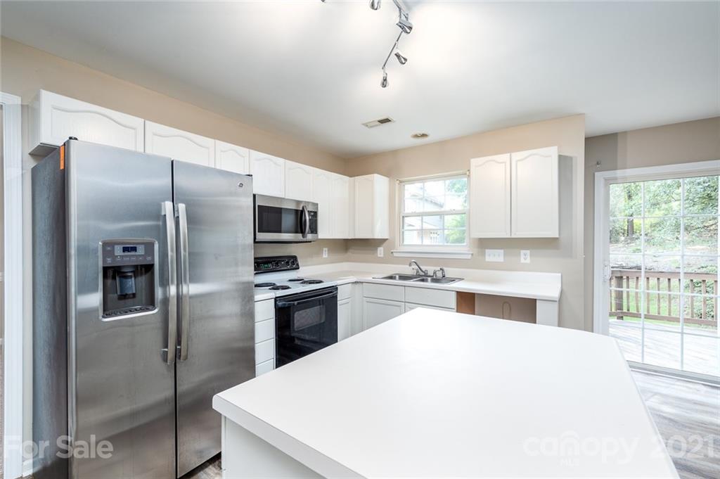 840 Knightsbridge Road Fort Mill, SC 29708 - Photo 13 of 32 a large kitchen with a large window stainless steel appliances and cabinets