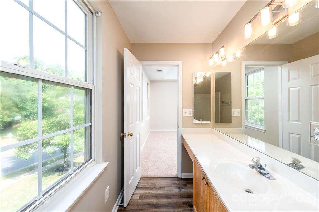 840 Knightsbridge Road Fort Mill, SC 29708 - Photo 18 of 32 a bathroom with a double vanity sink and mirror with large window