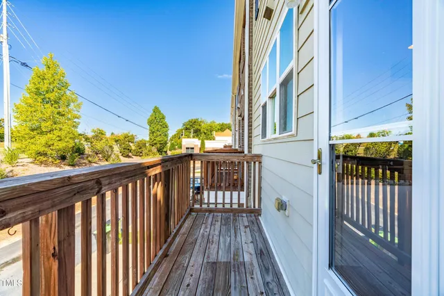 a view of a balcony with wooden floor