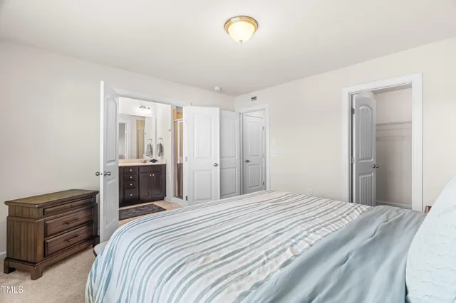 a bedroom with a bed and a television