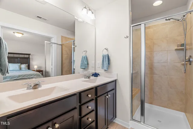 a bathroom with a sink double vanity and a shower