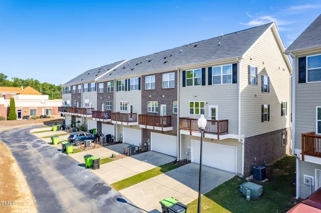 a view of a house with swimming pool and sitting area