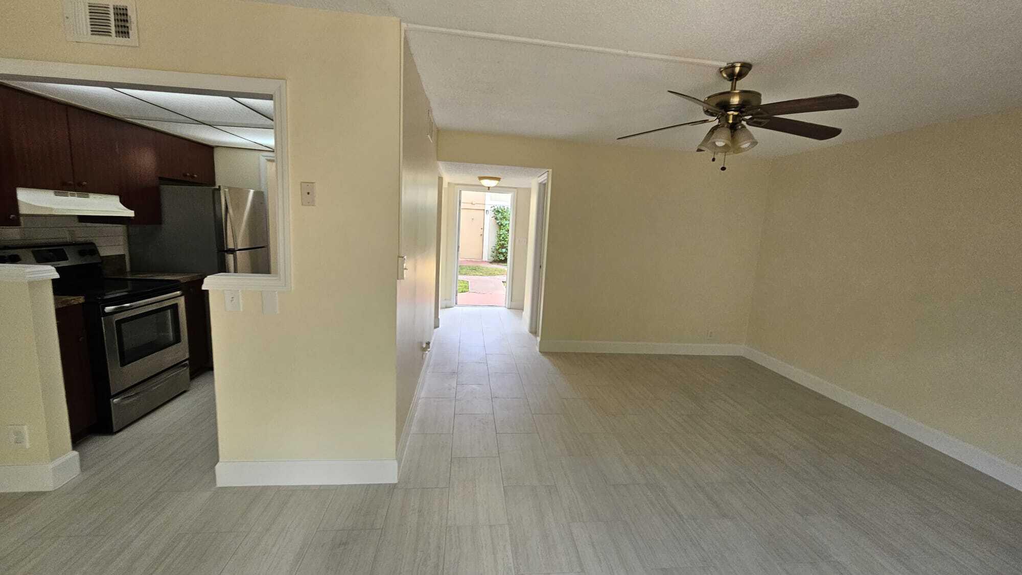 8801 West Sample Road, Unit 11 Coral Springs, FL 33065 - Photo 1 of 25 a view of a kitchen from the hallway