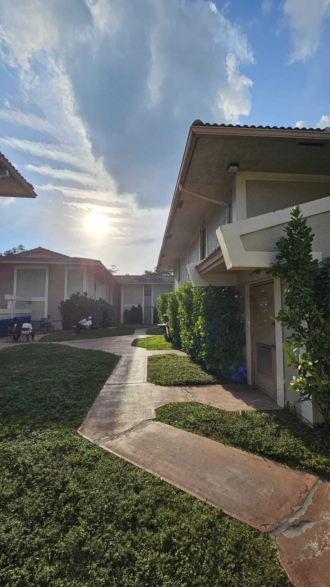 8801 West Sample Road, Unit 11 Coral Springs, FL 33065 - Photo 25 of 25 a view of a house with a yard