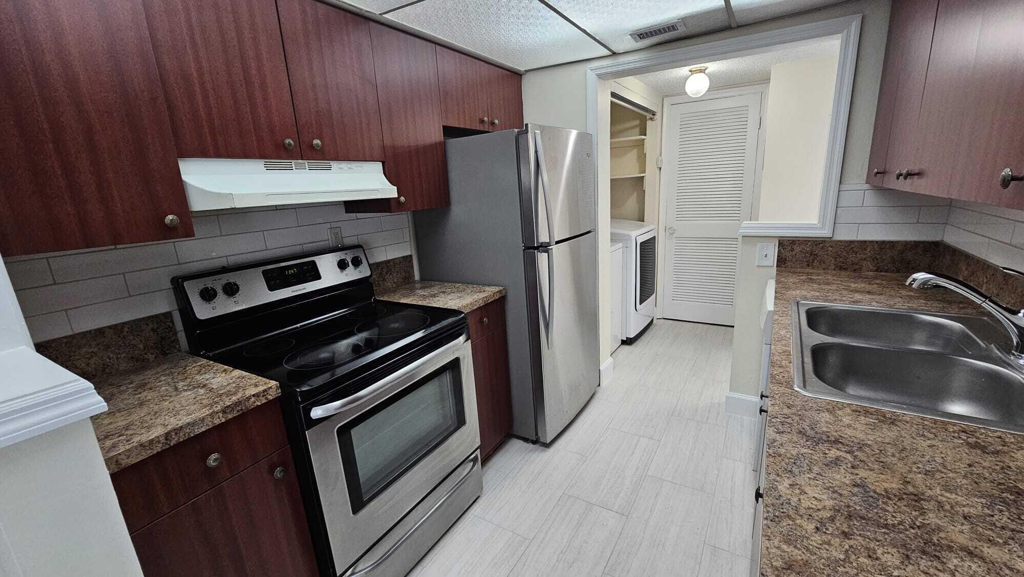 8801 West Sample Road, Unit 11 Coral Springs, FL 33065 - Photo 7 of 25 a kitchen with a stove microwave and refrigerator