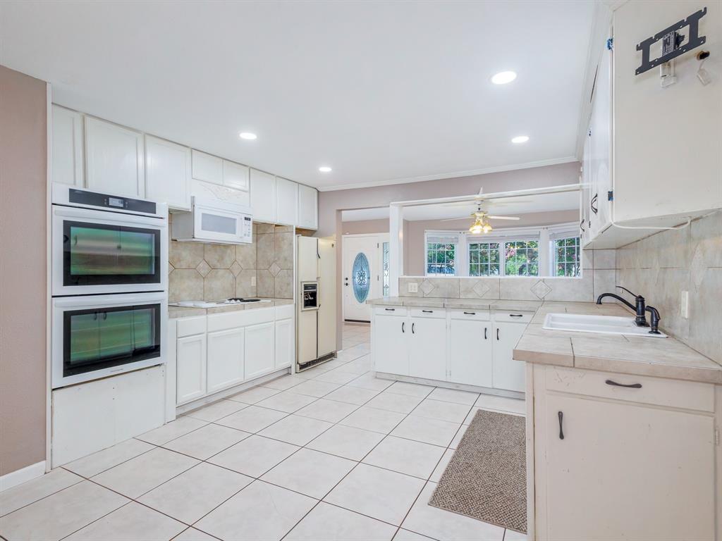 4002 Austin Avenue Brownwood, TX 76801 - Photo 7 of 34 a kitchen with a sink cabinets and stainless steel appliances