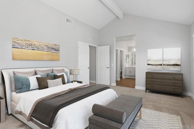 a bedroom with a large bed and a large window