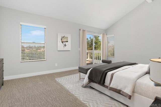 a bathroom with a tub a sink and a large mirror