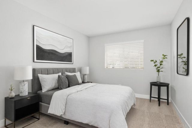 a bedroom with bed and wall painting with wooden floor