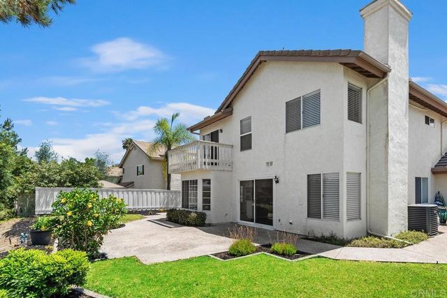 a view of a yard with plants and trees