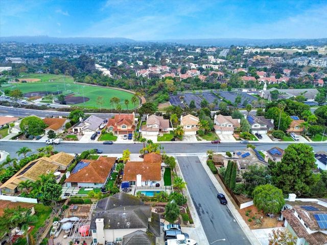 a kitchen with cabinets stainless steel appliances and wooden floor