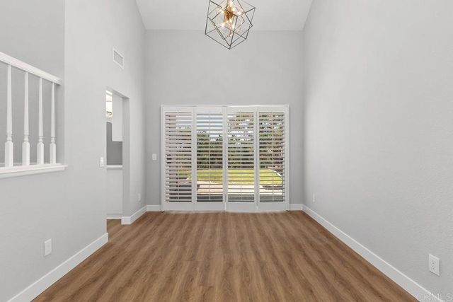 a view of a kitchen with wooden floor and a window