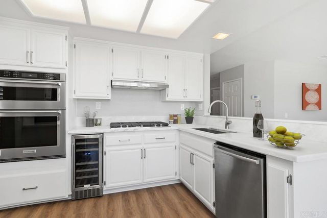a kitchen with a sink stove and cabinets