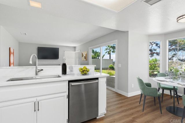 a kitchen with a sink cabinets and wooden floor