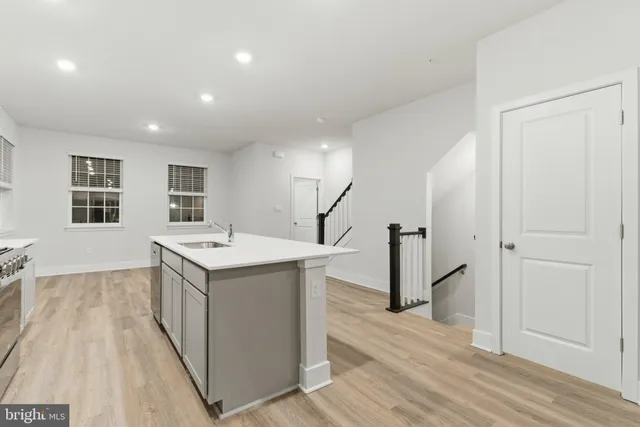 a view of a kitchen with wooden floor and electronic appliances