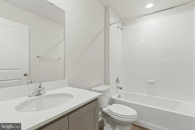 a bathroom with a sink toilet vanity and shower