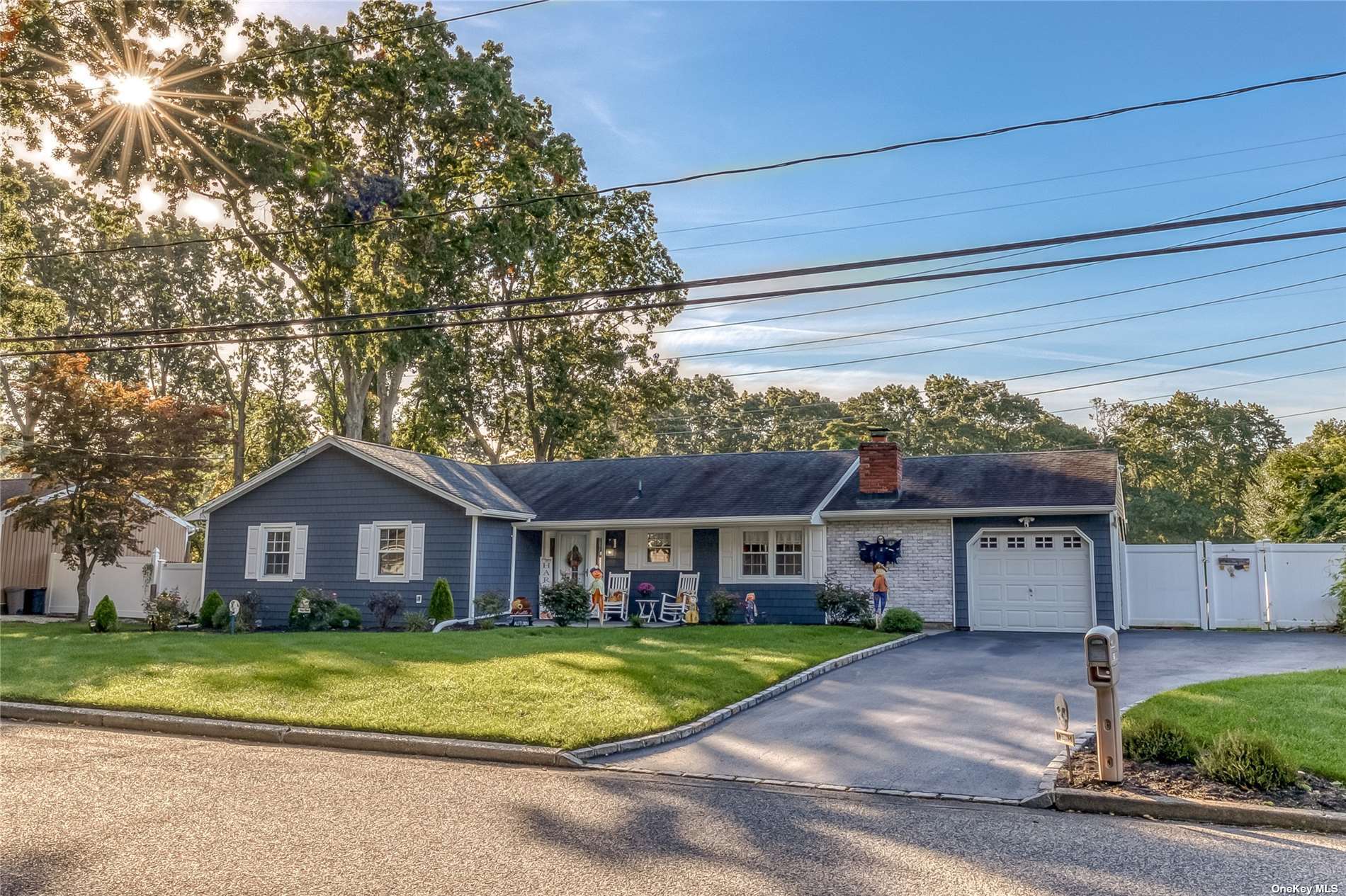 60 Mahogany Road Rocky Point, NY 11778 - Photo 1 of 1 a front view of a house with a garden and trees