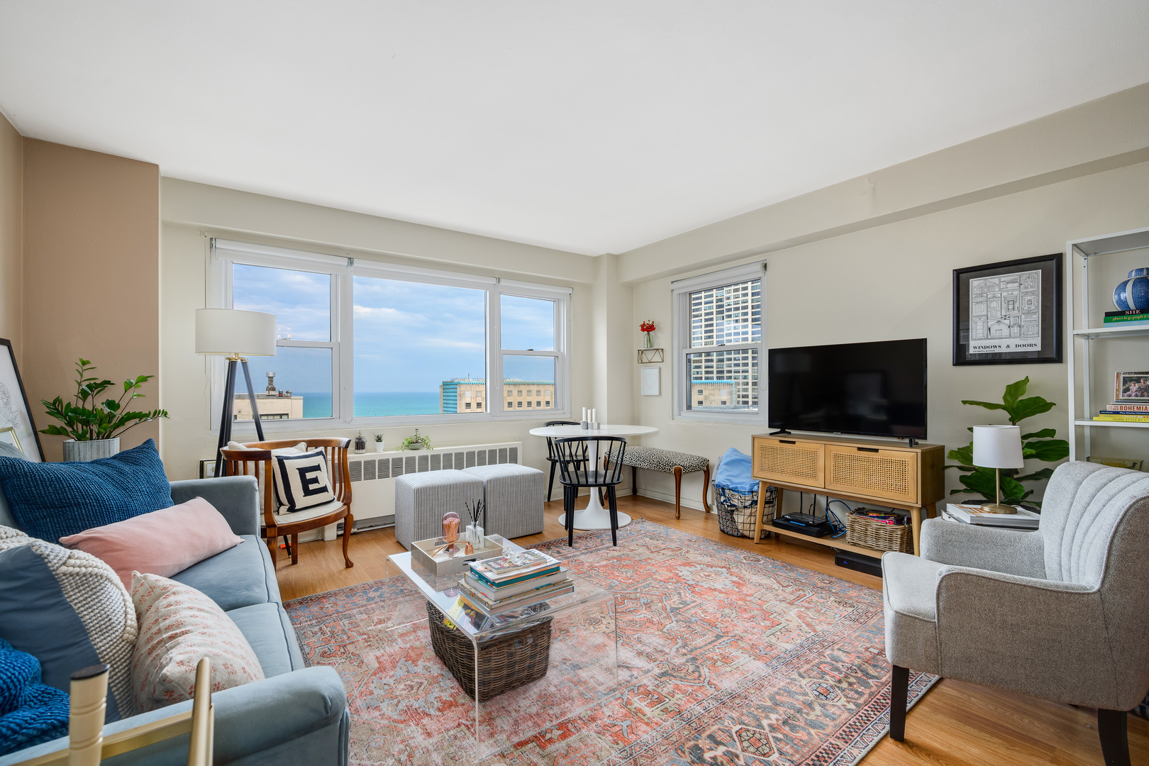 2909 North Sheridan Road, Unit 1803 Chicago, IL 60657 - Photo 2 of 16 a living room with furniture and a flat screen tv