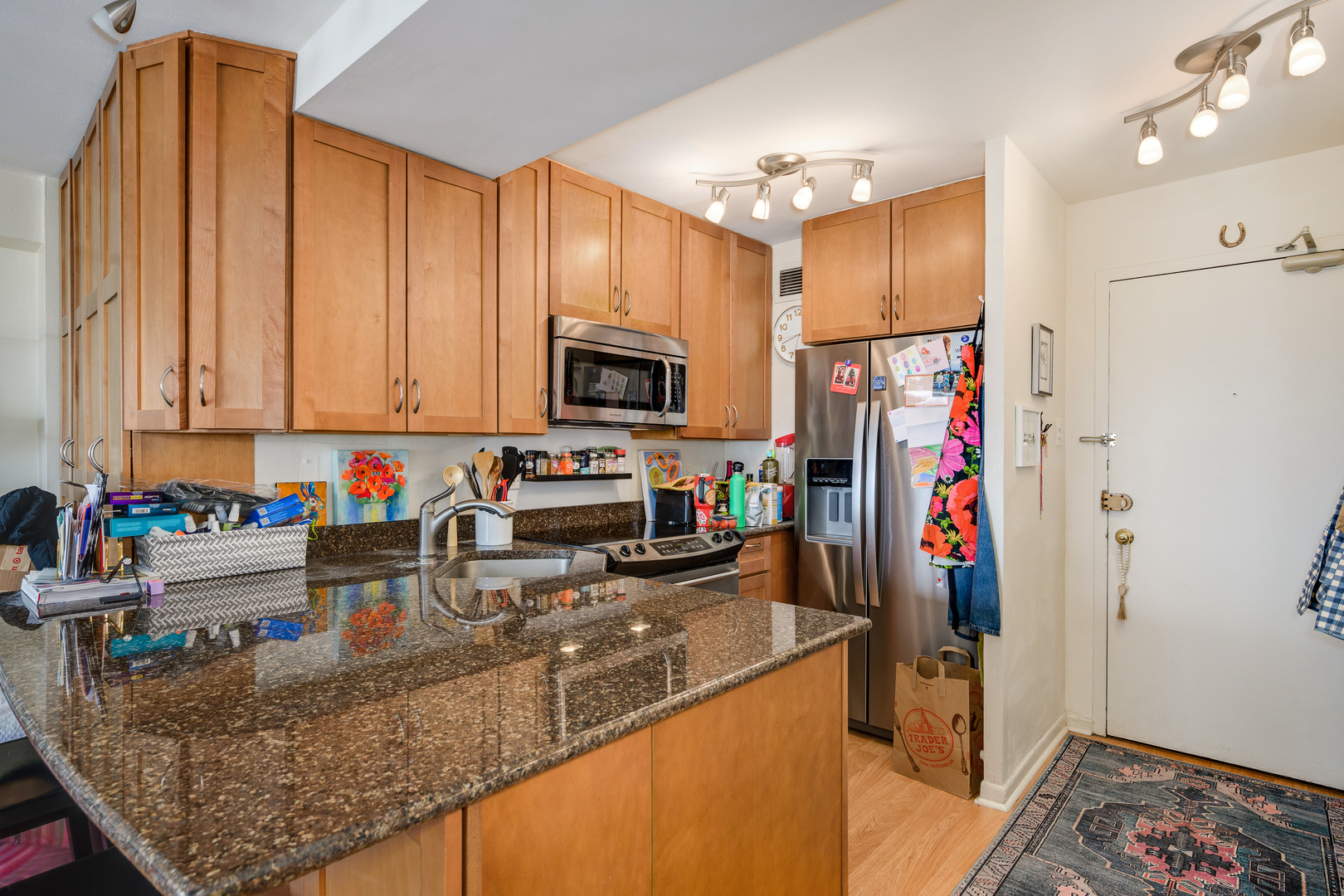 2909 North Sheridan Road, Unit 1803 Chicago, IL 60657 - Photo 6 of 16 a kitchen with stainless steel appliances granite countertop a refrigerator sink and stove