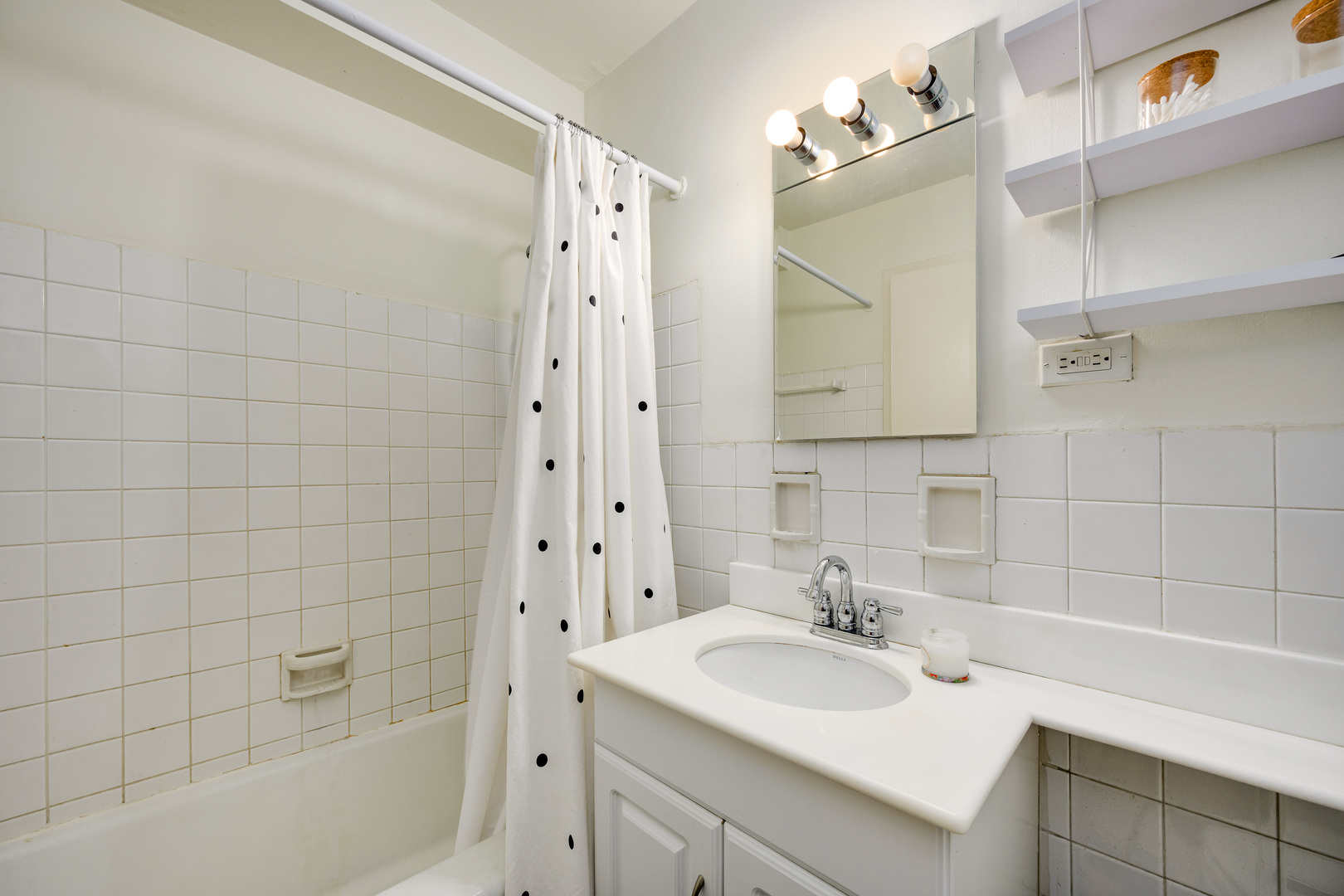 2909 North Sheridan Road, Unit 1803 Chicago, IL 60657 - Photo 10 of 16 a bathroom with a sink and a mirror