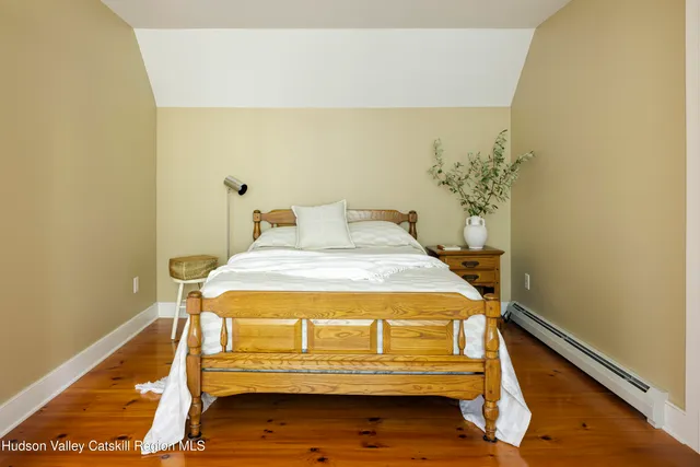 a bed sitting in a bedroom next to a wall