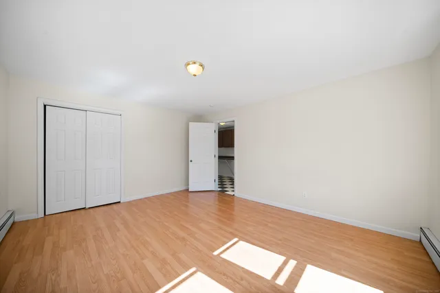 a view of an empty room and wooden floor
