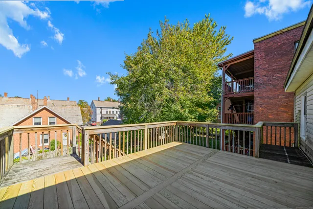 a view of a house with wooden deck