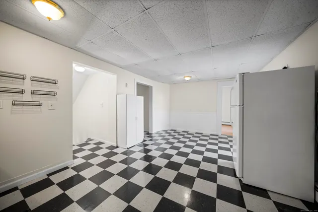a bathroom with a black and white checkered floor